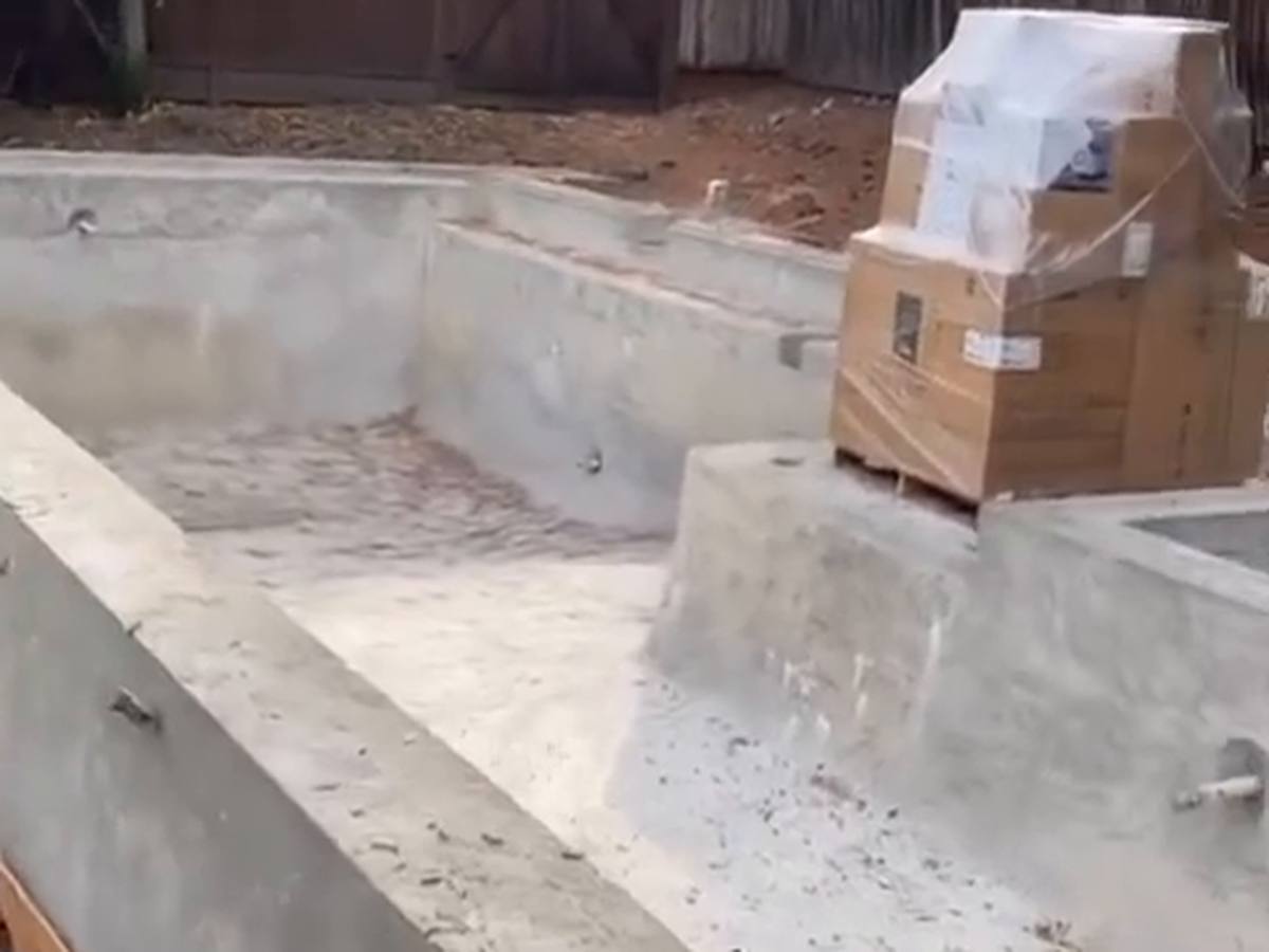 Poured concrete foundation walls and pier pads with anchor bolts on a finished subgrade